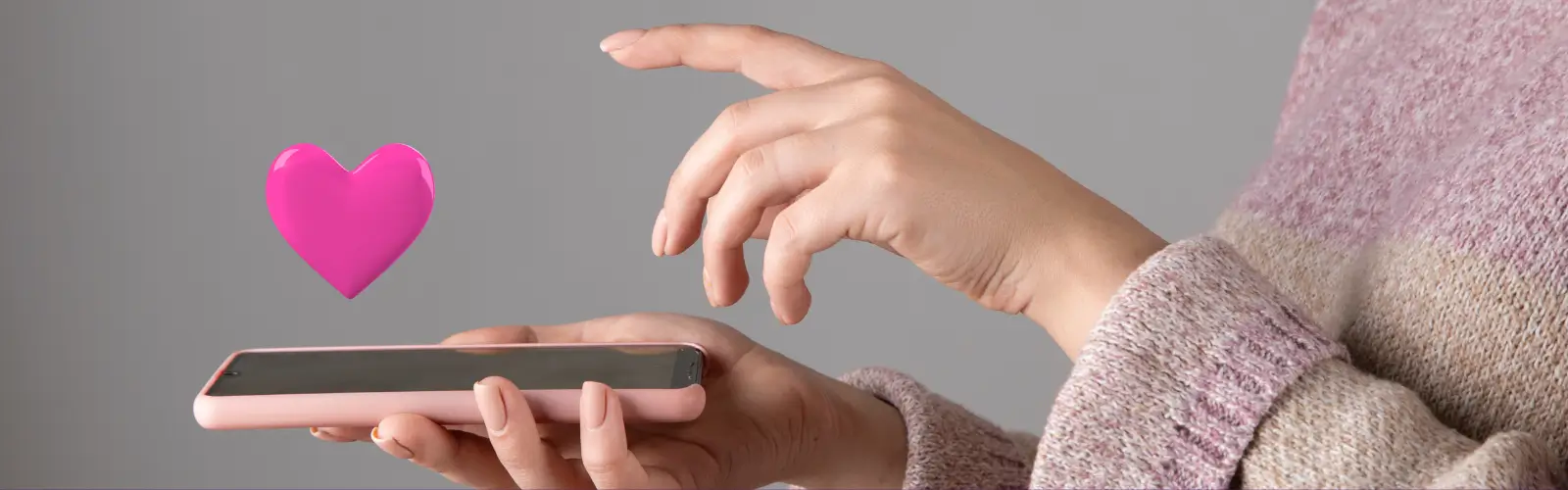partnersuche-kostenlos-liebe-herz-app Hände halten ein Smartphone mit einem schwebenden rosa Herz, das eine digitale Liebe oder einen Match symbolisiert.